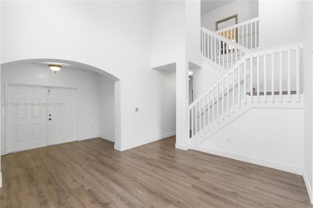 entrance foyer with a high ceiling and hardwood / wood-style floors