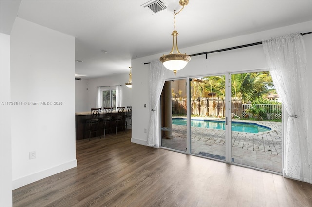 unfurnished room with dark wood-type flooring