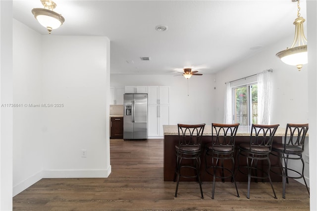 dining room with dark hardwood / wood-style flooring and ceiling fan