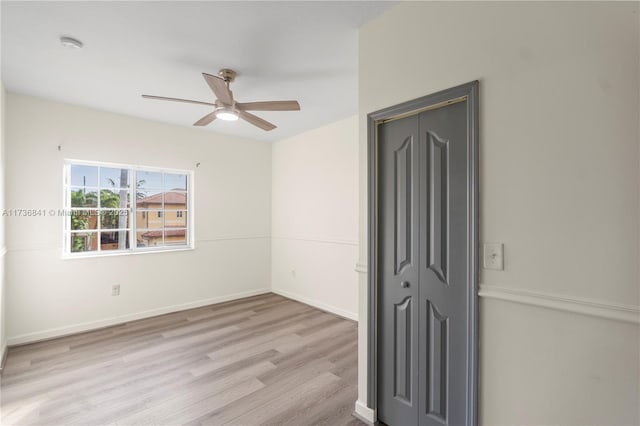 empty room featuring ceiling fan and light hardwood / wood-style floors