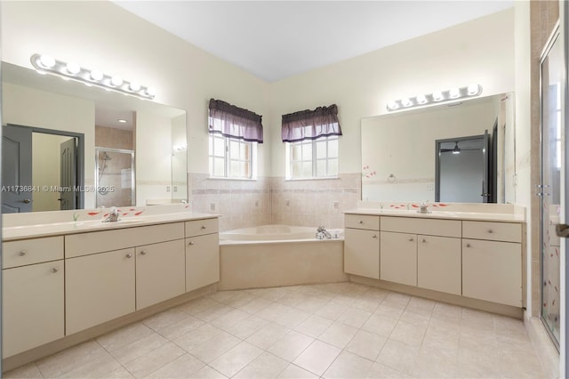 bathroom featuring vanity, tile patterned floors, and shower with separate bathtub