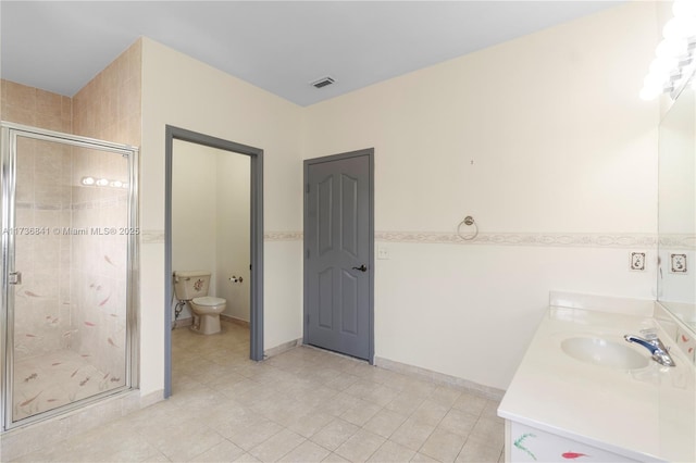 bathroom featuring vanity, toilet, and an enclosed shower