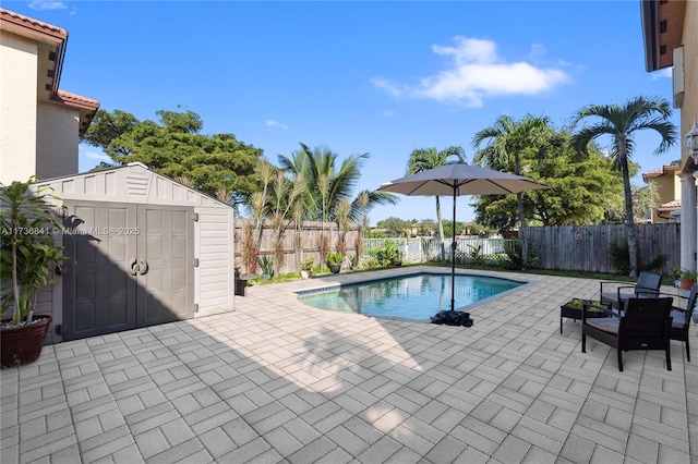 view of swimming pool featuring a storage shed and a patio