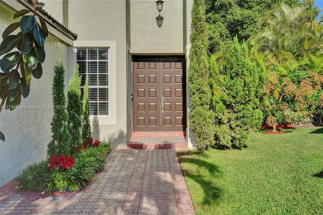 property entrance with a yard