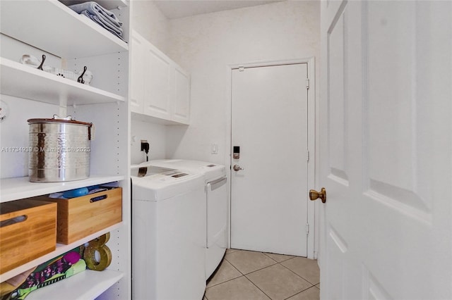 laundry room with cabinets, washing machine and clothes dryer, and light tile patterned flooring