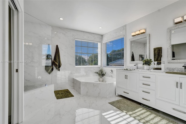 bathroom with vanity and separate shower and tub