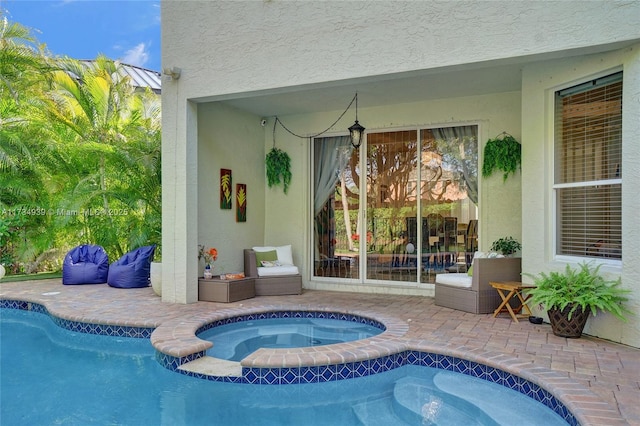 view of pool with a patio and an in ground hot tub