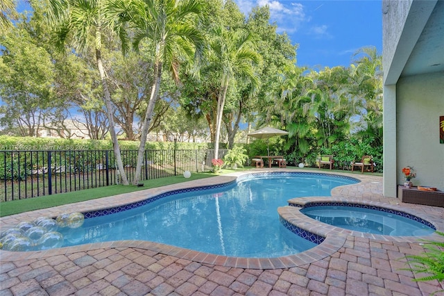 view of pool featuring an in ground hot tub