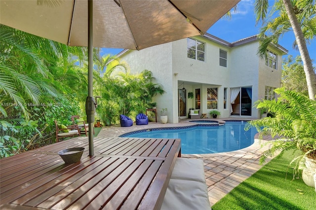 view of swimming pool with a patio and an in ground hot tub