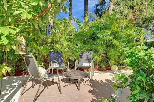 view of patio / terrace featuring an outdoor fire pit