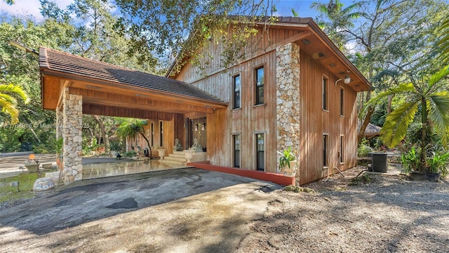 rear view of property featuring central AC unit