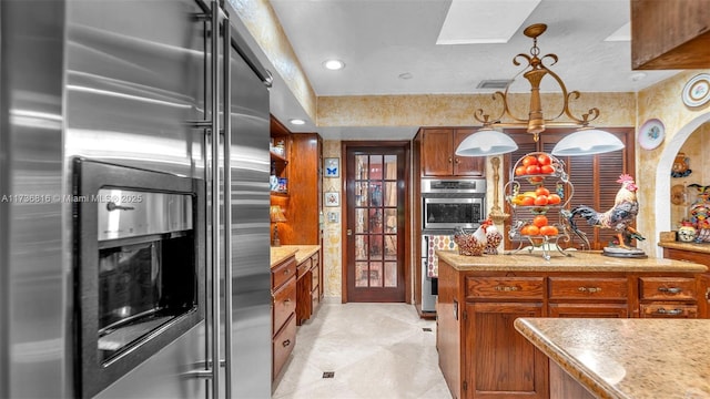 kitchen featuring stainless steel refrigerator with ice dispenser, decorative light fixtures, and light tile patterned floors