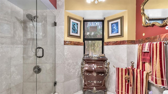 bathroom featuring an enclosed shower and tile walls