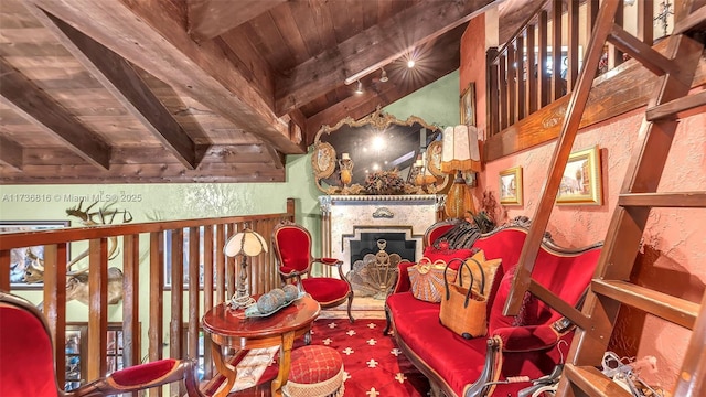 living area featuring beam ceiling and wooden ceiling