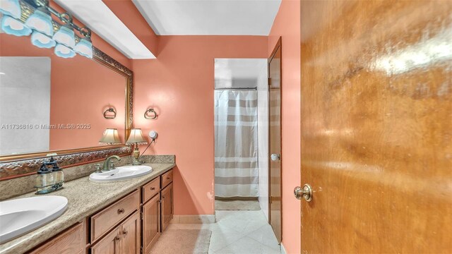 bathroom featuring tile patterned floors, vanity, and a shower with shower curtain