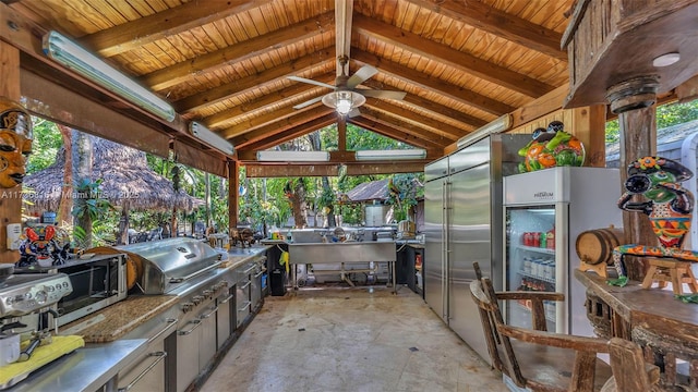 view of patio with area for grilling, a gazebo, ceiling fan, and exterior kitchen