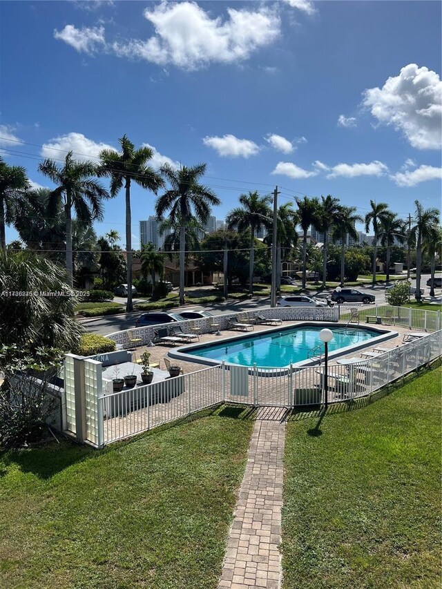 view of pool featuring a yard