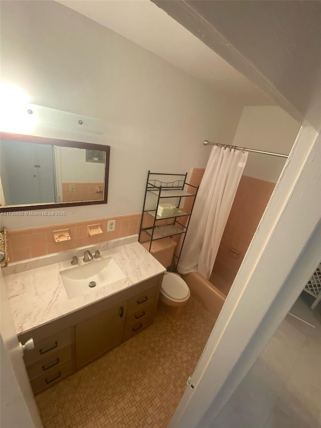 full bath with tile patterned floors, shower / bathtub combination with curtain, toilet, and vanity