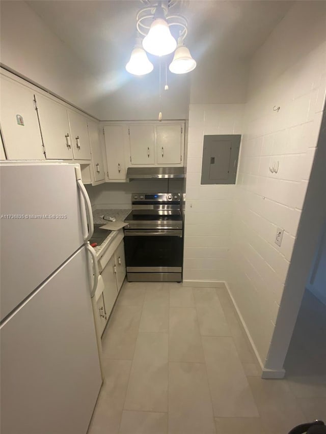 kitchen featuring electric range, electric panel, white cabinets, and freestanding refrigerator