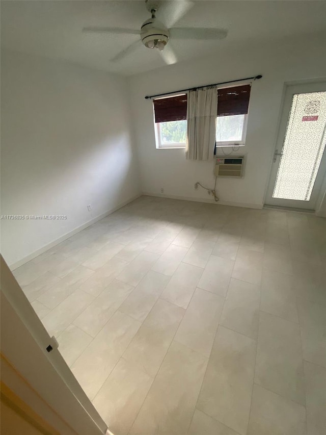 empty room featuring cooling unit and a ceiling fan