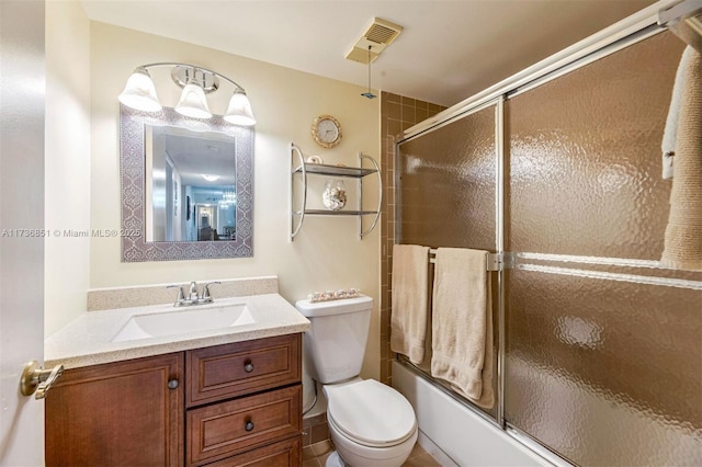 full bath featuring toilet, enclosed tub / shower combo, visible vents, and vanity