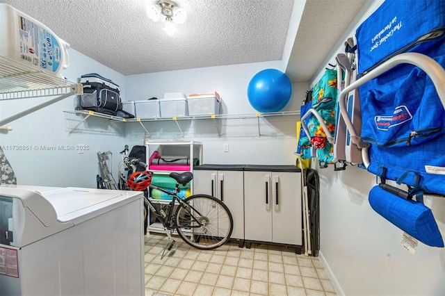 laundry room with a textured ceiling and laundry area