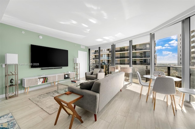 living room with light wood-type flooring and a wall of windows