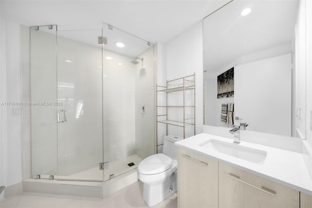 bathroom with vanity, a shower with shower door, and toilet