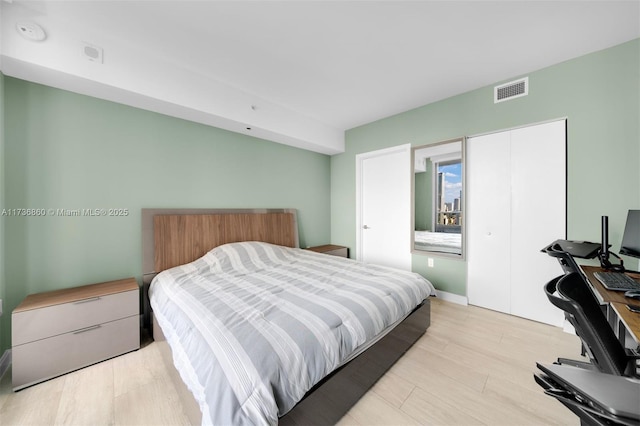 bedroom featuring light hardwood / wood-style floors and a closet