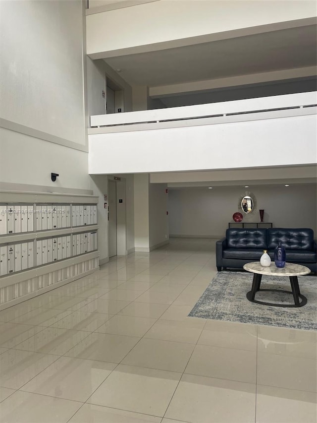 interior space with elevator, a towering ceiling, and mail boxes