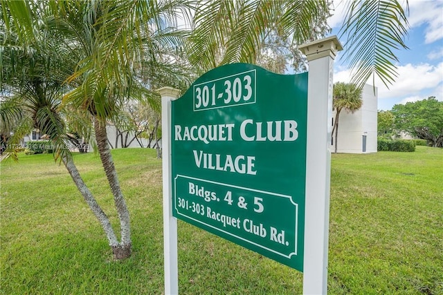 community sign featuring a lawn