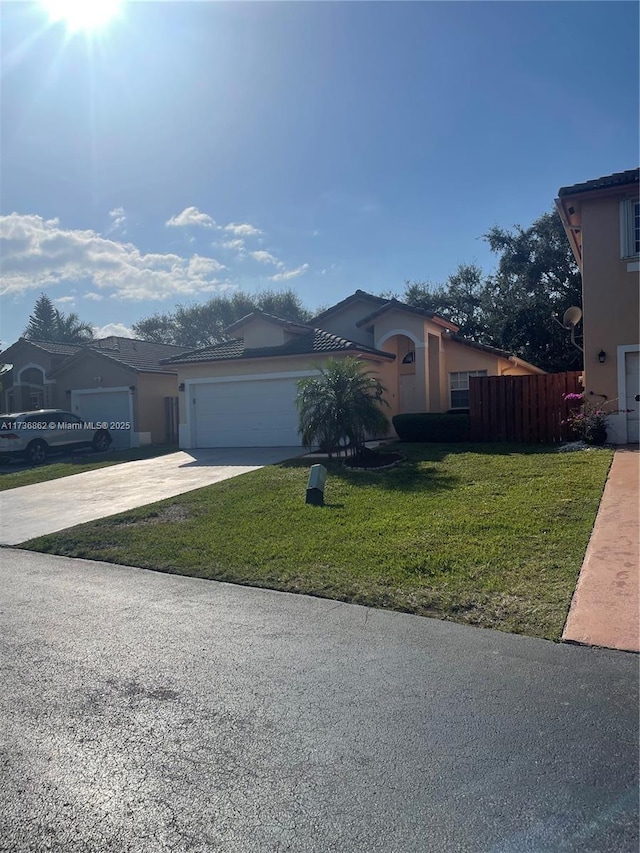 view of front of house featuring a garage and a front yard