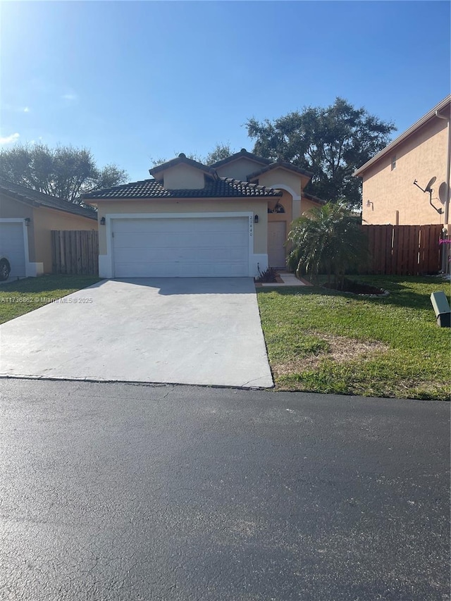 view of front of house featuring a garage and a front lawn