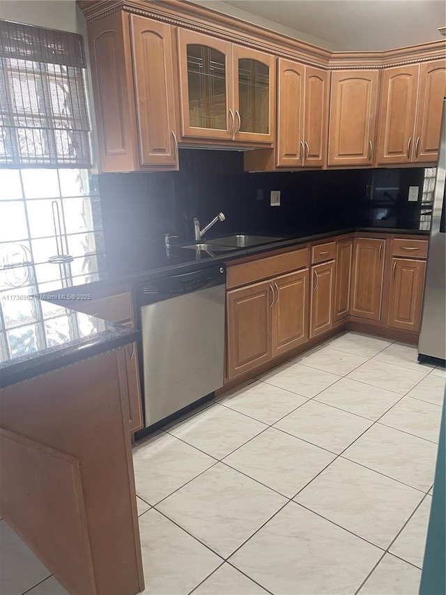 kitchen featuring sink, decorative backsplash, stainless steel appliances, and light tile patterned flooring