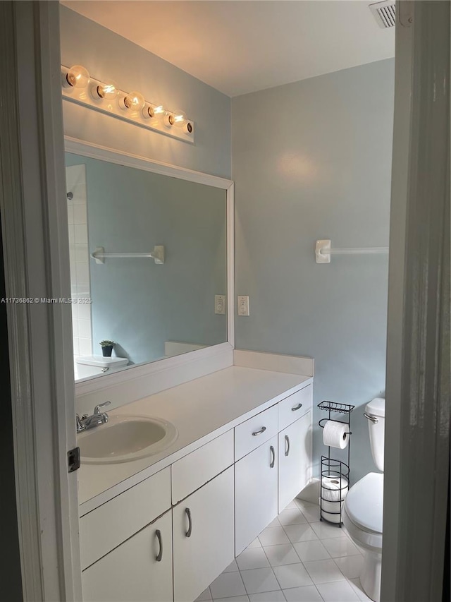 bathroom with toilet, tile patterned floors, visible vents, and vanity