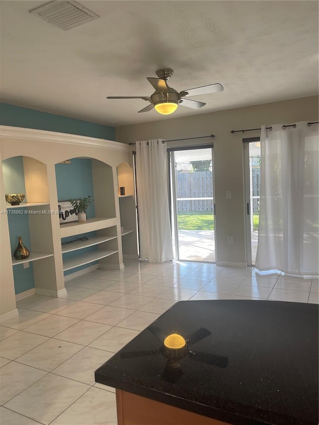 kitchen featuring ceiling fan, visible vents, and light tile patterned flooring