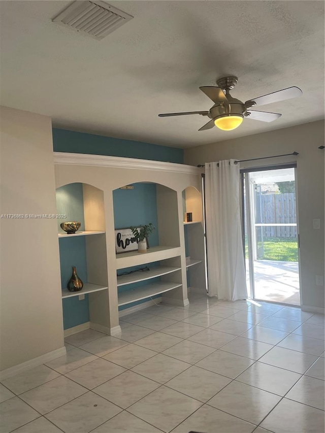 interior space with built in features, a textured ceiling, and ceiling fan