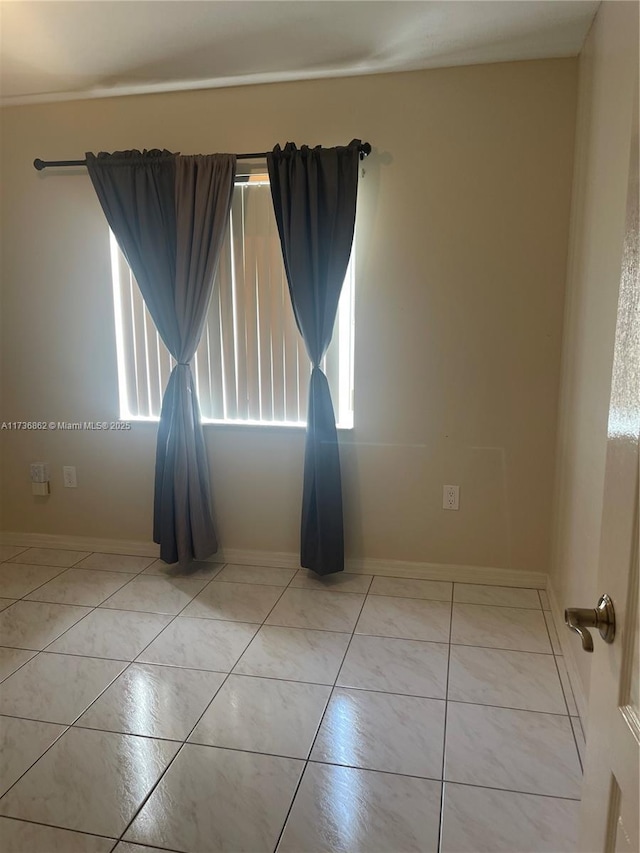 unfurnished room with light tile patterned floors