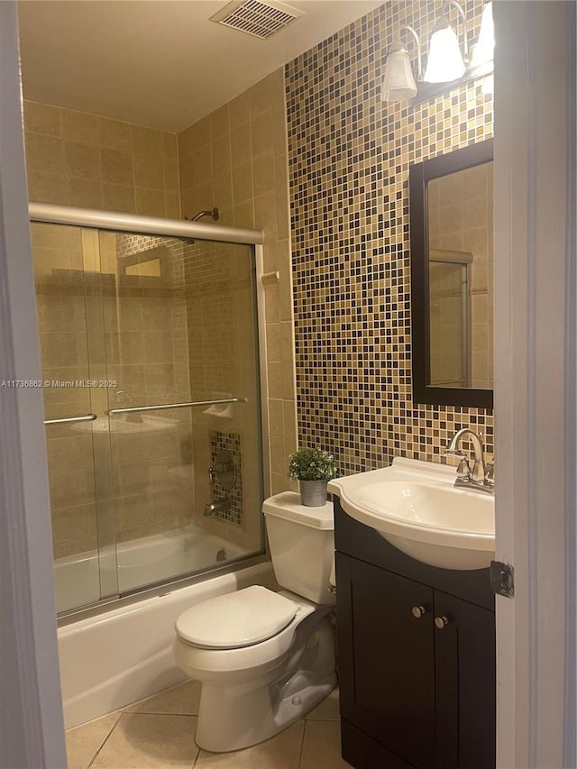 full bath with toilet, enclosed tub / shower combo, tile walls, and tile patterned floors