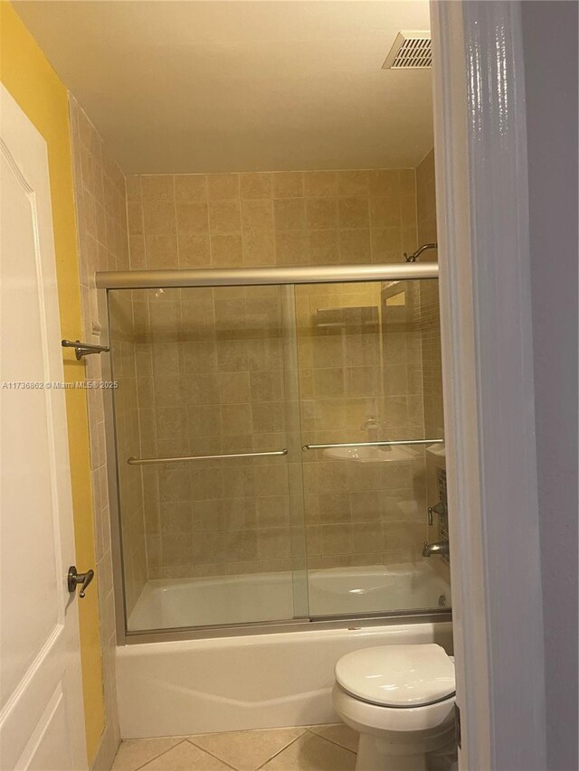 bathroom with shower / bath combination with glass door, toilet, and tile patterned flooring