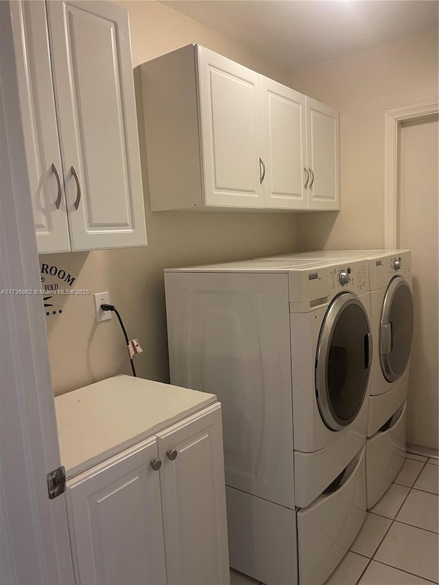 washroom with cabinets, light tile patterned floors, and independent washer and dryer