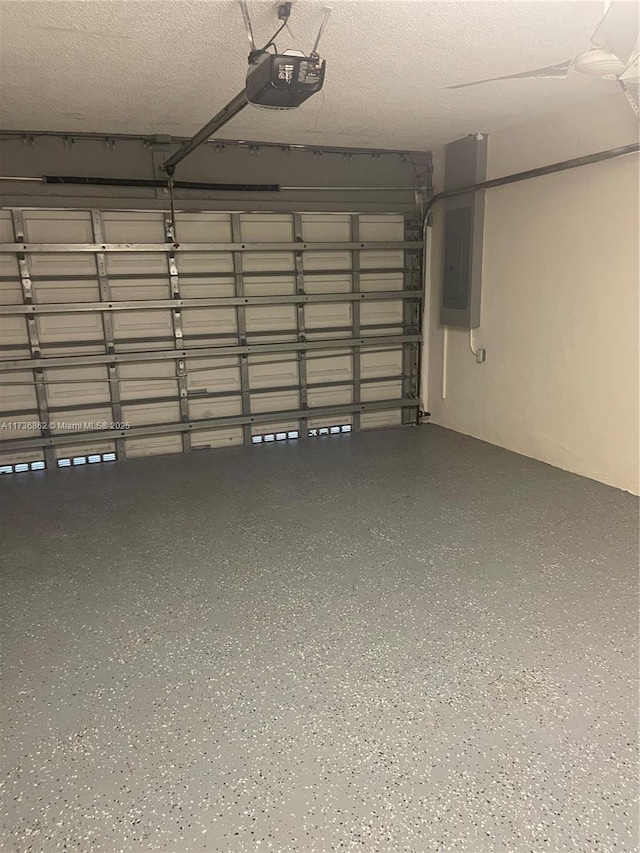 garage with a garage door opener and electric panel