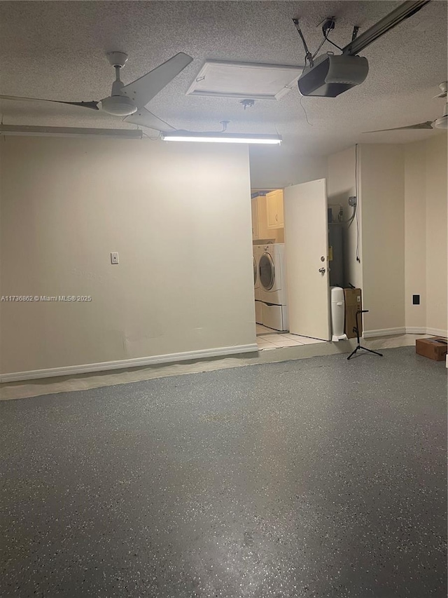 garage featuring a garage door opener, washer / dryer, and ceiling fan