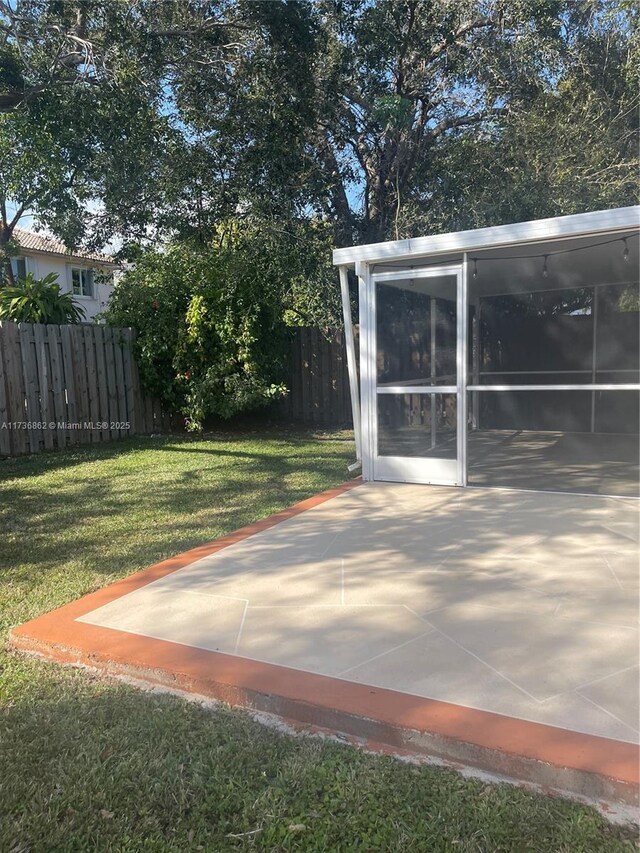 view of patio / terrace featuring a sunroom