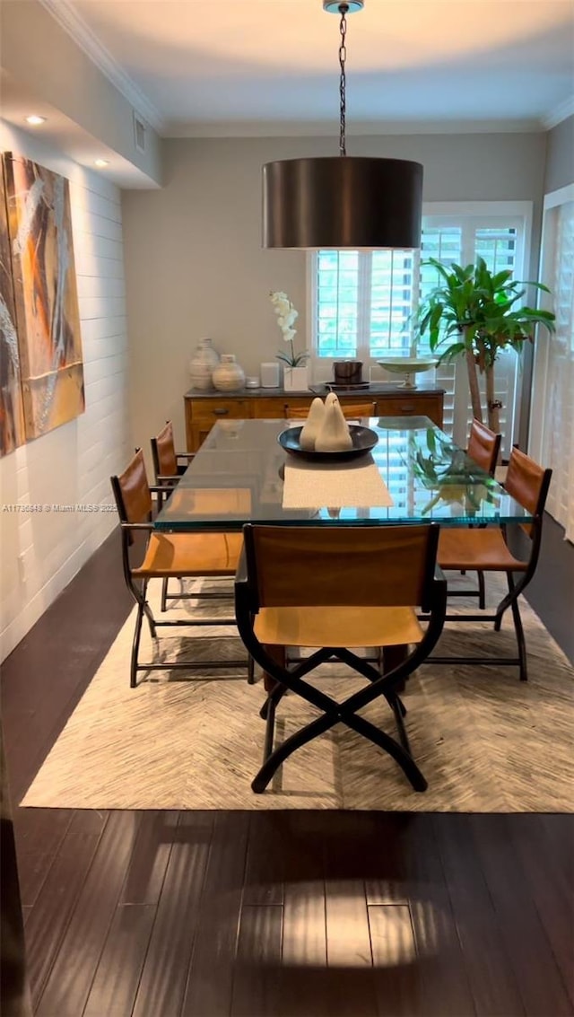 dining room featuring hardwood / wood-style flooring and crown molding