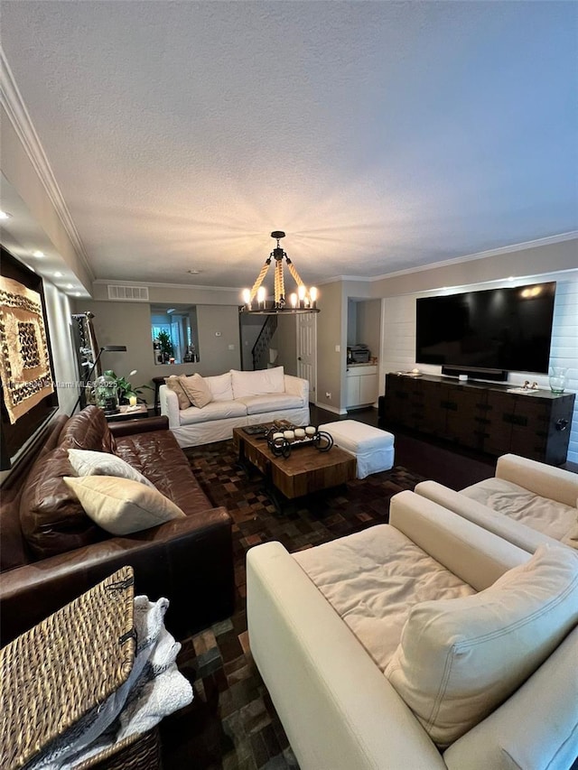 living room with crown molding, a textured ceiling, and a chandelier