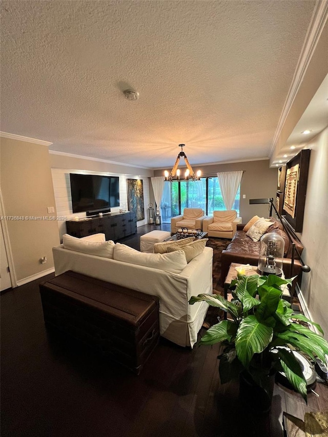 living room featuring ornamental molding, wood-type flooring, a textured ceiling, and an inviting chandelier