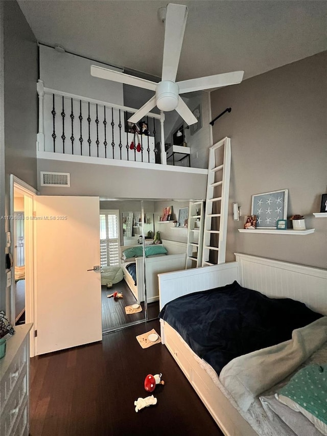 bedroom featuring dark hardwood / wood-style floors and a high ceiling