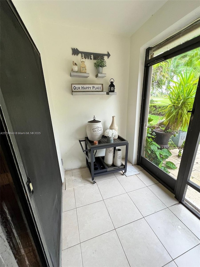 doorway to outside featuring light tile patterned flooring