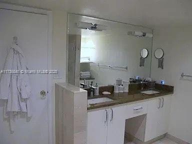 bathroom featuring vanity and a shower